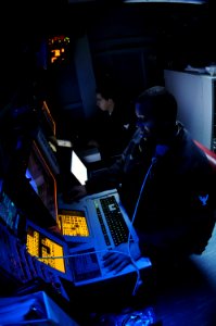 US Navy 090730-N-2344B-014 Operations Specialist 3rd Class David Bevels stands the auto track manager and identification operator watch in the Combat Direction Center aboard the aircraft carrier USS Ronald Reagan (CVN 76)