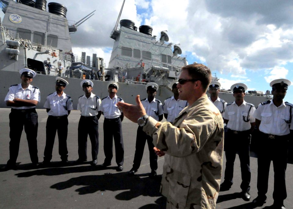 US Navy 090731-N-6138K-444 Ensign Tyson Meadors, the force protection officer assigned to the guided-missile destroyer USS Arleigh Burke (DDG 51), instructs Sailors from Mauritius National Coast Guard on visit, board, search, a