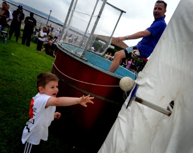 US Navy 090731-N-7280V-440 Capt. Thom W. Burke, commanding officer of the amphibious command ship USS Blue Ridge (LCC-19), gets dunked in the dunk tank by the son of a Blue Ridge officer
