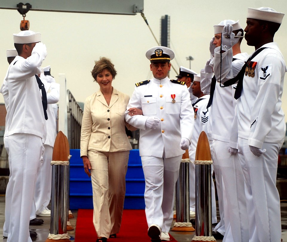 US Navy 090731-N-3090M-517 Former first lady and ship's sponsor Laura Bush is escorted by sonar officer Lt. j.g. Cliff Jessop as she departs the Virginia-class attack submarine USS Texas (SSN 775) change of command ceremony