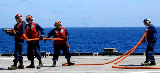 US Navy 090805-A-7779L-022 Sailors assigned to the Harpers Ferry-class dock landing ship USS Oak Hill (LSD 51) man the fire hose during a fire-fighting drill on the flight deck