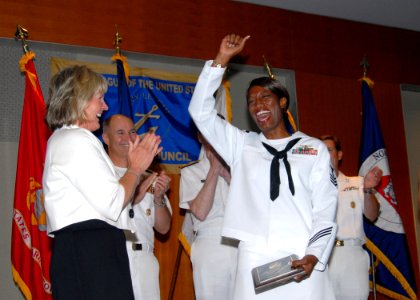 US Navy 090731-N-9860Y-003 Personnel Specialist 1st Class Gladys Willis, assigned to Patrol Squadron (VP) 1, celebrates after being notified in a cell phone call by her executive officer, Cmdr. Troy Bauder, of her selection as