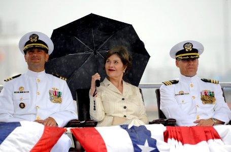 US Navy 090731-N-8467N-001 Cmdr. Robert A. Roncska, left, former first lady Laura Bush and Cmdr. James L. Gray listen to the remarks of guest speaker, retired Capt. Karl M. Hasslinger, during a change of command ceremony