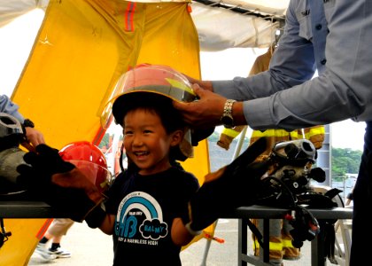 US Navy 090801-N-7478G-131 A child dons a fire helmet aboard the amphibious command ship USS Blue Ridge (LCC 19) during the Commander, Fleet Activities Yokosuka 33rd annual Friendship Day
