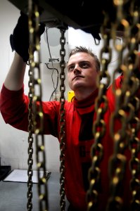 US Navy 090804-N-3610L-327 Aviation Ordnanceman 2nd Class Tyler Corbin, from Edwardsville, Ill., performs routine maintenance on a half-ton manual hoist aboard the aircraft carrier USS Ronald Reagan (CVN 76)