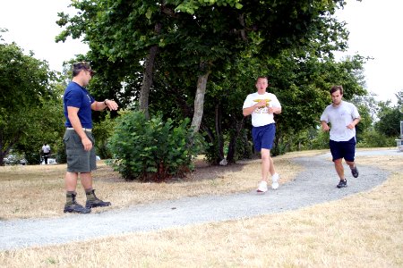 US Navy 090804-N-5366K-094 Chief Special Warfare Operator (SEAL) Jason Torey keeps time as KNDD radio station host Andrew Harms, right, runs 1.5 miles to practice for the Navy SEAL Fitness Challenge at Surrey Downs Park