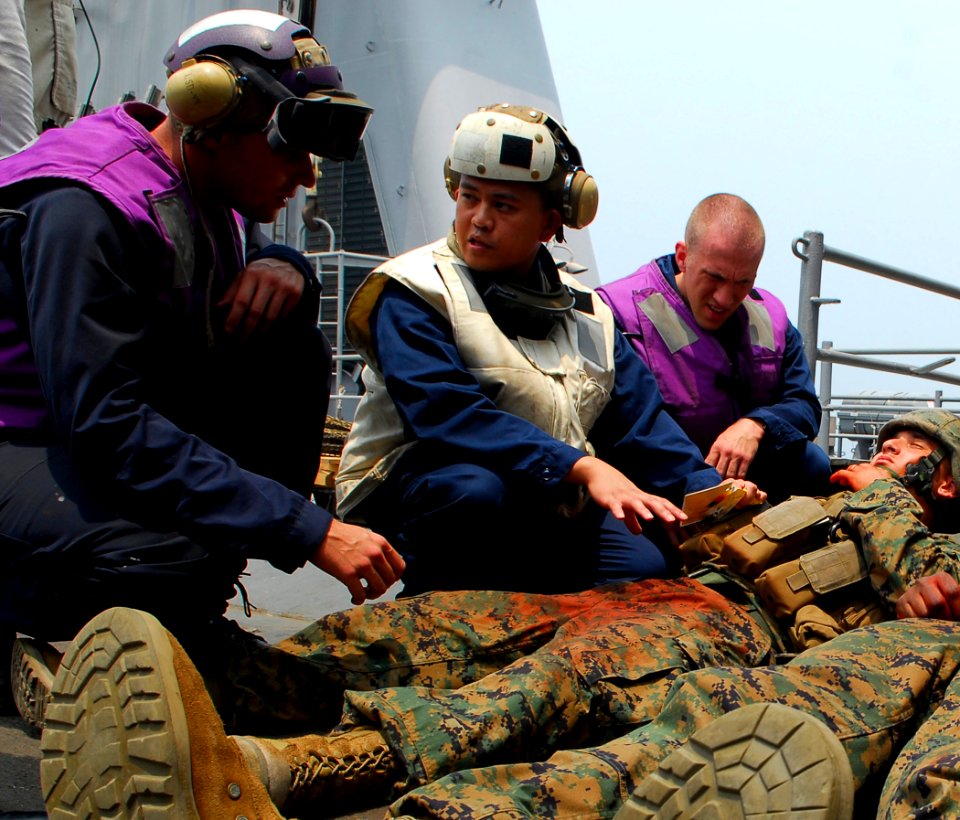 US Navy 090806-N-5207L-036 Hospital Corpsman 1st Class Jason Amos, assigned to the dock landing ship USS Harpers Ferry (LSD 49), diagnoses injuries to a simulated landslide survivor
