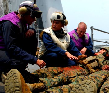 US Navy 090806-N-5207L-036 Hospital Corpsman 1st Class Jason Amos, assigned to the dock landing ship USS Harpers Ferry (LSD 49), diagnoses injuries to a simulated landslide survivor