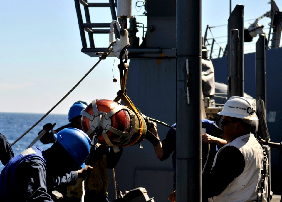 US Navy 090805-N-2638R-003 Sailors guide a MK-46 recoverable exercise torpedo (REXTORP) safely to the deck of the Arleigh Burke-class guided-missile destroyer USS Mustin (DDG 89) during a REXTORP exercise