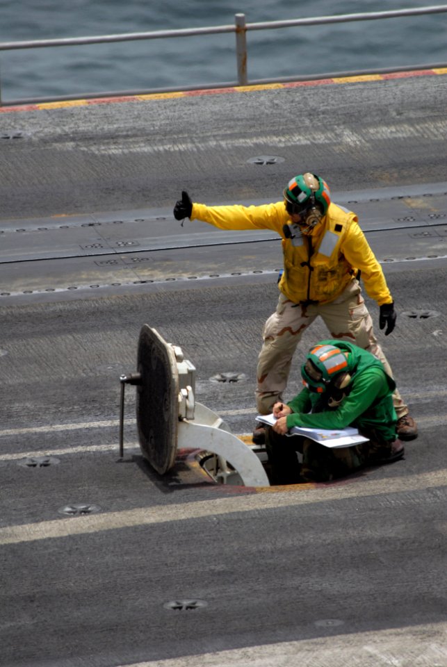 US Navy 090801-N-9132C-064 Aviation Boatswain's Mate (Equipment) 3rd Class James Deguise makes sure the catapult is ready to launch an aircraft off of the flight deck of the aircraft carrier USS Ronald Reagan (CVN 76)
