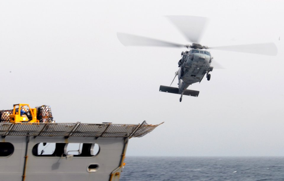 US Navy 090807-N-5586R-134 An MH-60S Sea Hawk helicopter takes part in a replenishment at sea with Military Sealift Command fast combat-support ship USNS Rainier (T-AOE 7)