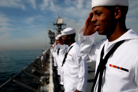 US Navy 090803-N-8878B-207 Sailors aboard the amphibious assault ship pre-commissioning unit Makin Island (LHD 8) render honors while manning the rails as the ship pulls into Rio De Janeiro photo