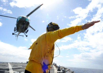 US Navy 090803-N-6138K-530 Landing signalman enlisted Boatswain's Mate Seaman Dustin Cochran guides a Mauritius National Coast Guard Alouette Class III helicopter during flight operations aboard the guided-missile destroyer USS photo