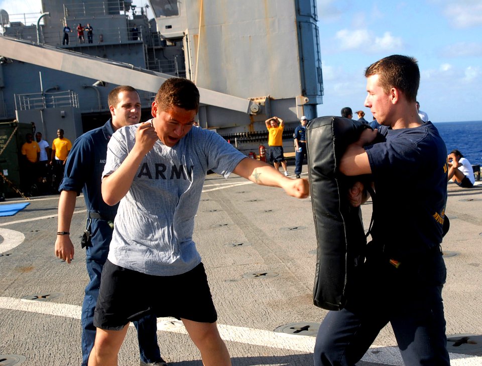 US Navy 090802-A-7779L-038 Pvt. Cory Torres, assigned to the 55th Signal Company, Combat Camera, based at Ft. Meade, Md. strikes a punching pad during Oleoresin Capsicum (OC) Spray qualifications