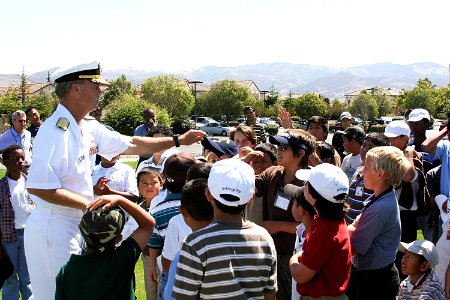 US Navy 090804-N-3038C-053 Rear Adm. Robert L. Thomas Jr., director of Strategy and Policy Division (N51), awards a Navy ball cap at The First Tee of Monterey County photo