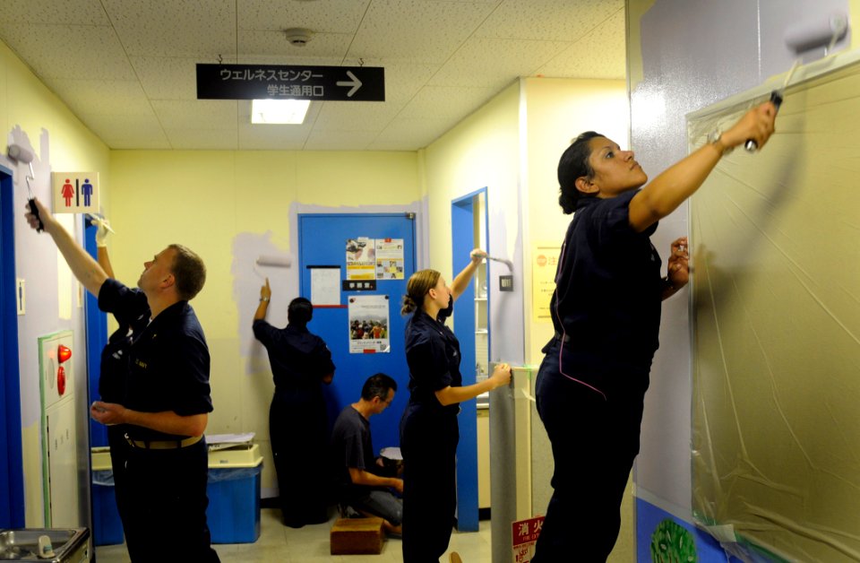 US Navy 090804-N-7280V-401 Sailors assigned to the amphibious command ship USS Blue Ridge (LCC 19) and embarked Seventh Fleet staff Sailors paint a classroom in the Tokyo YMCA International School during a community service pro