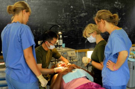 US Navy 090808-N-9689V-002 Canadian dentist, Army Capt. Jason Yee, and Canadian dental technician, Army Cpl. Lori Nason, provide dental treatment to a local woman during a Pacific Partnership 2009 photo