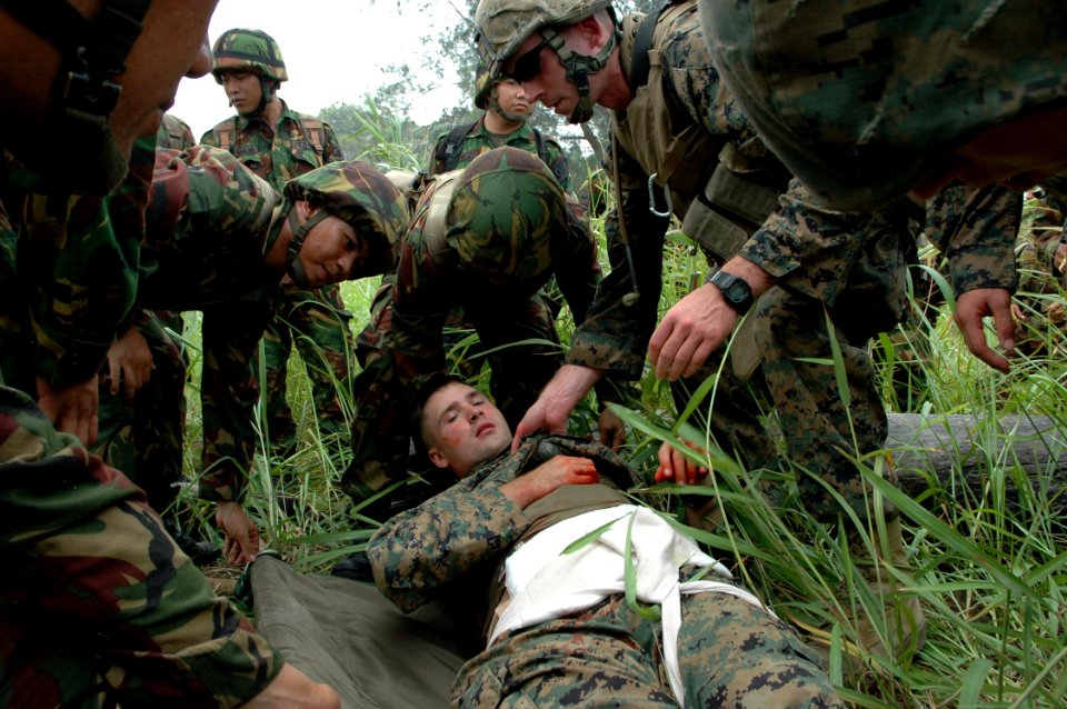 US Navy 090806-N-8539M-202 Royal Brunei Land Force soldiers and U.S. Marines load a simulated mudslide victim onto a stretcher