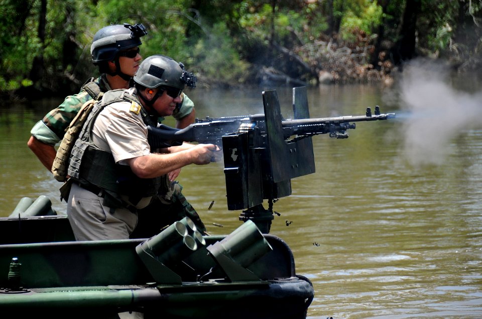 US Navy 090804-N-4205W-272 Romanian Navy Chief of Staff Adm. Gheorge Marin fires an M-240B machine gun during a visit to the Naval Small Craft Instruction and Technical Training School