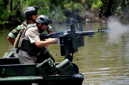 US Navy 090804-N-4205W-272 Romanian Navy Chief of Staff Adm. Gheorge Marin fires an M-240B machine gun during a visit to the Naval Small Craft Instruction and Technical Training School