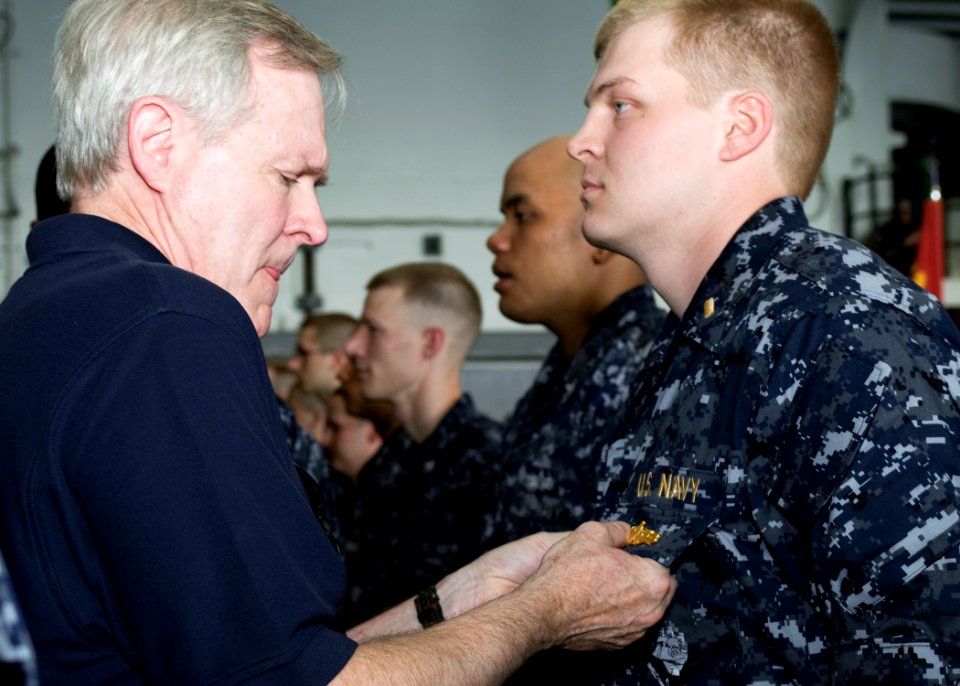 US Navy 090807-N-8655E-099 Secretary of the Navy (SECNAV) Ray Mabus pins the surface warfare officer pin on Ensign Jonathan Smiley, from Columbus, Ohio