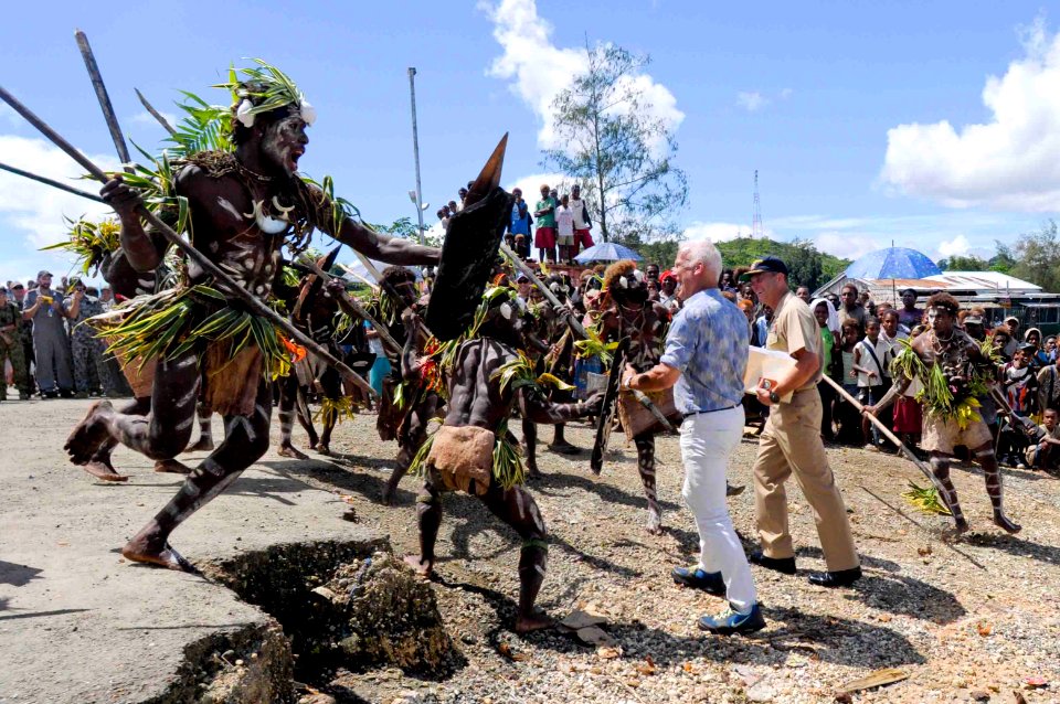 US Navy 090810-N-9689V-001 Capt. Andrew Cully, Pacific Partnership 2009 mission commander, and Paul Berg, Charge d'Affairs for the United States, receive a traditional warrior's welcome from Malaita Island villagers