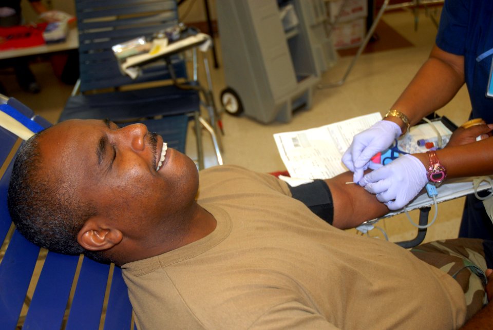 US Navy 090804-N-9564W-035 Yeoman 1st Class Timothy Gilbert, assigned to Headquarters Company of Naval Mobile Construction Battalion (NMCB 74), donates blood during a blood drive