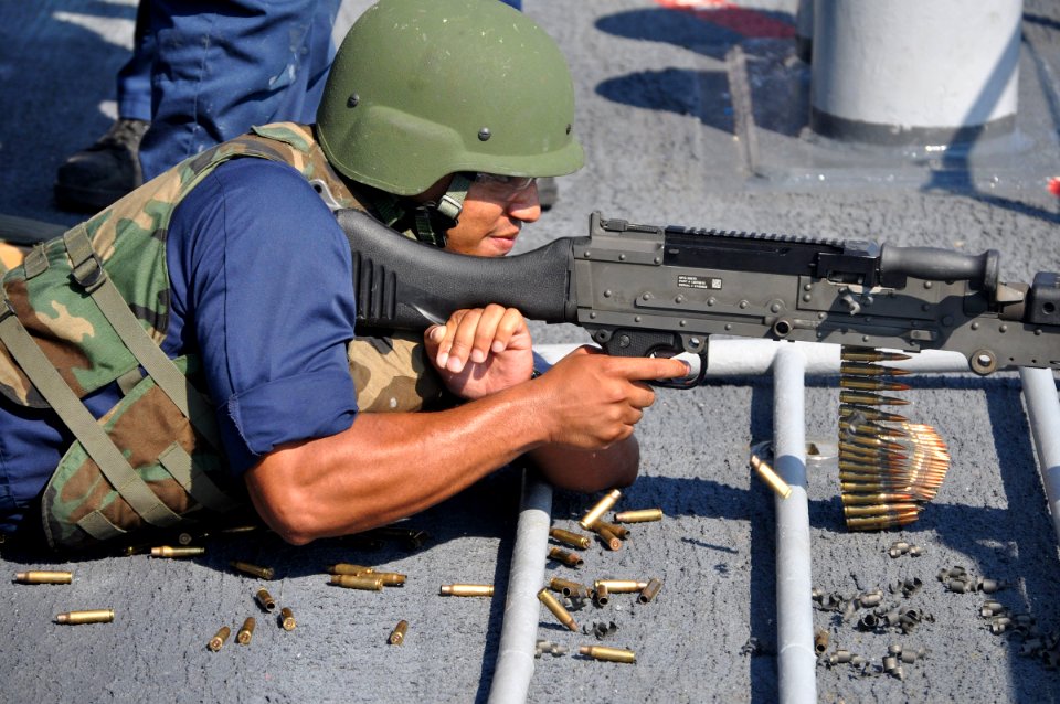 US Navy 090810-N-4124C-002 Ensign Michael A. Walker, assigned to the Ticonderoga-class guided-missile cruiser USS Normandy (CG 60), fires an M240B machine gun during a crew served weapons live-fire exercise