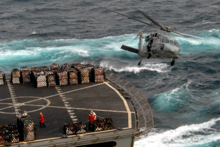 US Navy 090807-N-9132C-046 An MH-60S Sea Hawk helicopter assigned to the Black Jacks of Helicopter Sea Combat Squadron (HSC) 21 flies over the Military Sealift Command fast combat support ship USNS Rainier (T-AOE 7) during a re