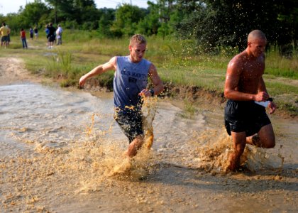 US Navy 090808-N-4267W-504 Competitors make their way through a mud pit during the 9th annual Health Net Armed Services YMCA Mud Run at Naval Amphibious Base Little Creek