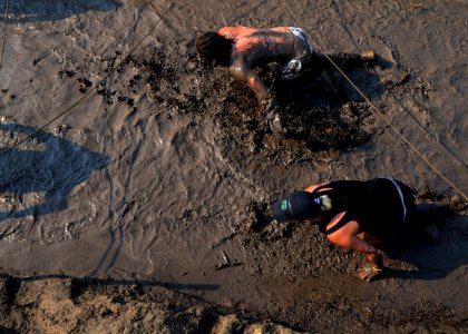 US Navy 090808-N-4267W-509 Competitors crawl their way through a mud pit during the 9th annual Health Net Armed Services YMCA Mud Run at Naval Amphibious Base Little Creek