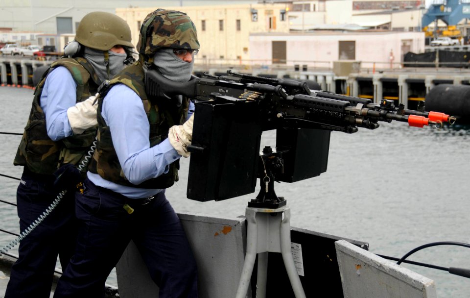 US Navy 090812-N-7498L-128 Gunner's Mate 3rd Class Justin Varner, from Camby, Texas, simulates firing an M-240 machine gun aboard the guided-missile destroyer as the ship defends itself from small boat attacks