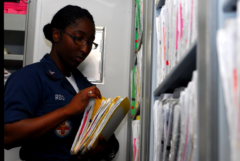 US Navy 090811-N-2918M-026 Hospital Corpsman 3rd Class Karla Reid files patient records in medical department aboard the nuclear powered aircraft carrier USS Nimitz (CVN 68)