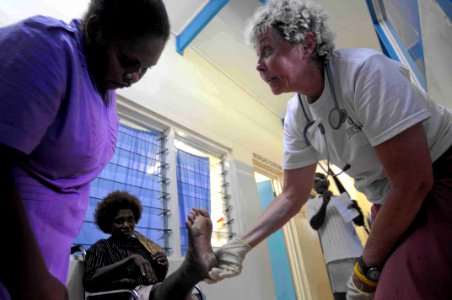 US Navy 090811-N-9689V-003 Kathleen Lefevre, a nurse practitioner from International Relief Team embarked aboard the Military Sealift Command dry cargo-ammunition ship USNS Richard E. Byrd (T-AKE 4) consults with patients
