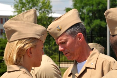 US Navy 090812-N-8848T-049 Cmdr. Donald Lesh, executive officer of the Chicago Naval ROTC Consortium, inspects an incoming freshman at Naval Station Great Lakes, Ill photo