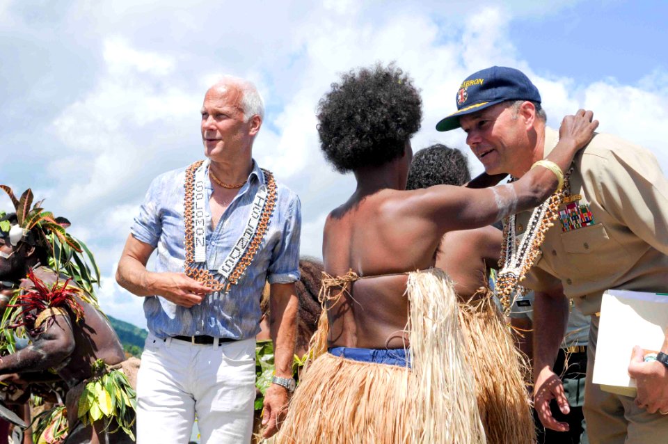 US Navy 090810-N-9689V-004 Capt. Andrew Cully, right, Pacific Partnership 2009 mission commander, and Paul Berg, Charge d'Affairs for the United States, receive gifts from Malaita Island villagers