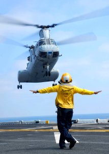 US Navy 090813-N-0515W-015 A landing signal enlisted (LSE) recovers a CH-46 Sea Knight on board USS Bonhomme Richard (LHD 6)