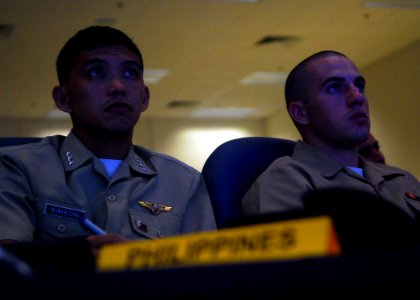 US Navy 090813-N-5207L-126 Ensign Daniel Royal assigned to the dock landing ship USS Harpers Ferry (LSD 49), and Lt. Mickey Simeon, a Philippine Navy officer, listens to a maritime law presentation