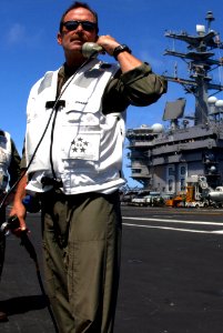 US Navy 090810-N-2600H-014 Capt. Michael C. Manazir, commanding officer of the aircraft carrier USS Nimitz (CVN 68) mans the landing signal officer position to observe the approach of Capt. Bret Batchelder