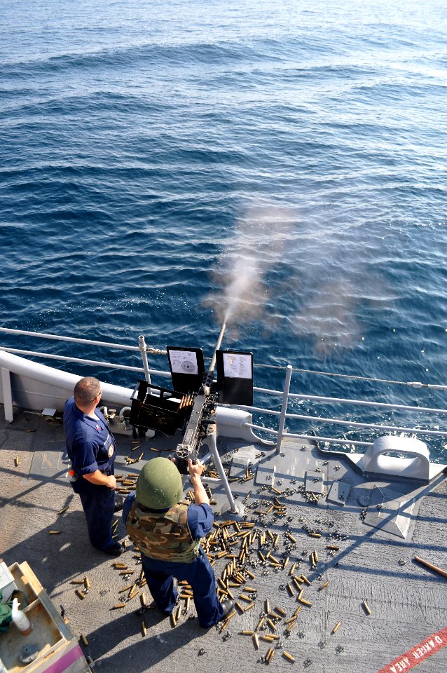 US Navy 090810-N-4124C-005 A member of the Ticonderoga-class guided-missile cruiser USS Normandy (CG 60), loads a .50 caliber machine gun during a crew served weapons live-fire exercise