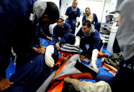 US Navy 090813-N-7280V-215 Sailors assigned to the amphibious command ship USS Blue Ridge (LCC 19) train how to place a casualty onto a stretcher in the ship's main battle dressing station during a general quarters drill