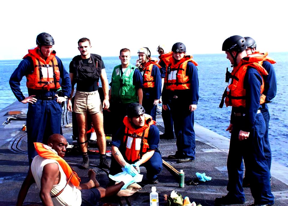 US Navy 090811-N-0000X-062 Sailors aboard the ballistic missile submarine USS Rhode Island (SSBN 740) render aid to five Bahamian nationals recovered from a capsized fishing vessel in the Atlantic Ocean