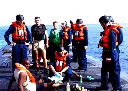 US Navy 090811-N-0000X-062 Sailors aboard the ballistic missile submarine USS Rhode Island (SSBN 740) render aid to five Bahamian nationals recovered from a capsized fishing vessel in the Atlantic Ocean