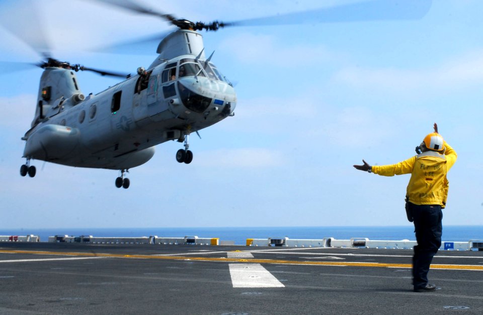 US Navy 090813-N-0515W-016 A landing signal enlisted (LSE) recovers a CH-46 Sea Knight on board USS Bonhomme Richard (LHD 6)