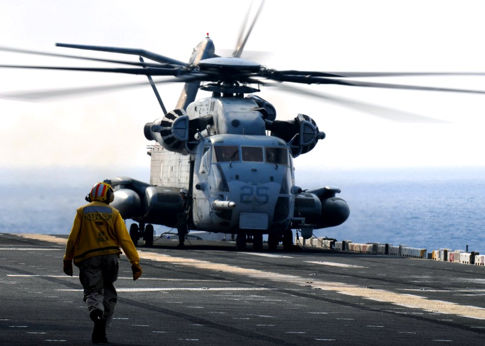 US Navy 090812-N-0120A-001 Chief Warant Officer 2 Latonya Wallace, air bosun aboard the forward-deployed amphibious assault ship USS Essex (LHD 2), walks along the flight deck to supervise the launch of a CH-53E Sea Stallion h