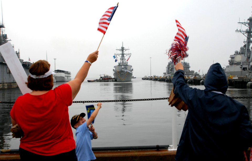 US Navy 090814-N-1688B-014 Family members and friends wait on the pier for the return of the Arleigh Burke-class guided-missile destroyer USS Mitscher (DDG 57) after a 200-day deployment