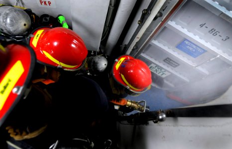 US Navy 090812-N-7280V-061 Sailors assigned to the flying squad aboard the amphibious command ship USS Blue Ridge (LCC 19) engage a simulated class-alpha fire photo
