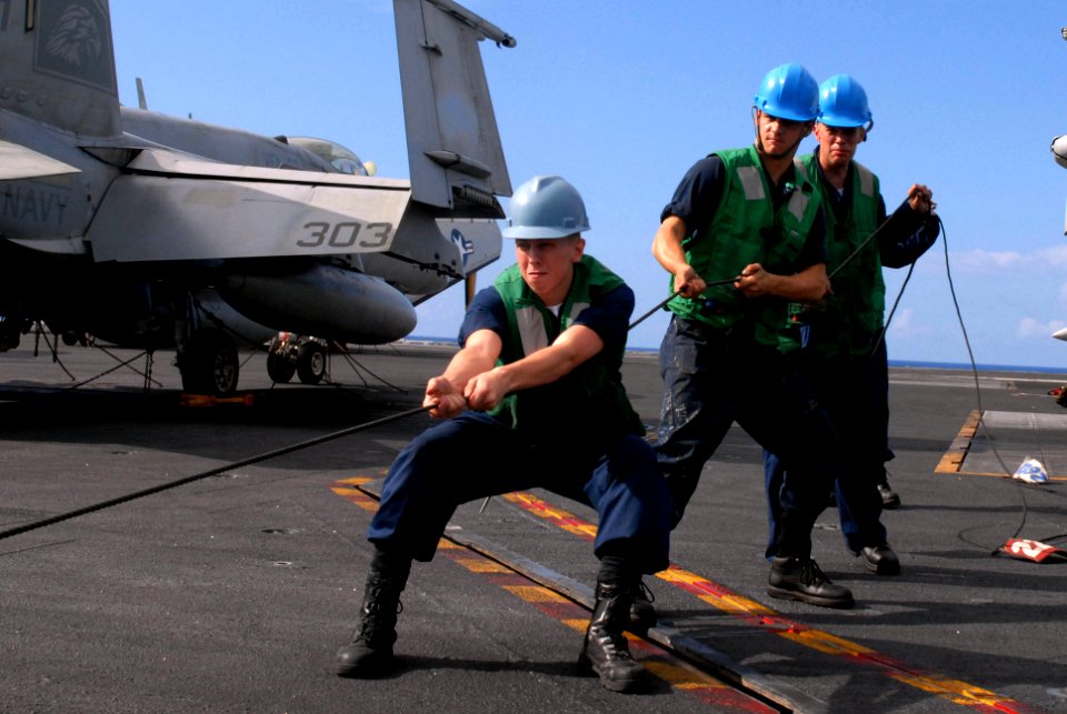 US Navy 090815-N-2600H-016 Sailors aboard the aircraft carrier USS Nimitz (CVN 68) handle lines and guide rigging during a replenishment at sea with the Military Sealift Command fast combat support ship USNS Bridge (T-AOE 10)