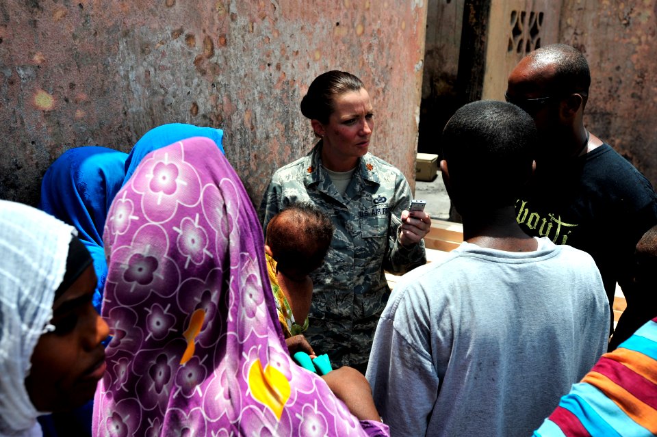US Navy 090812-N-0506A-326 U.S. Air Force public affairs officer, interviews a family in front of their burned home in Djibouti