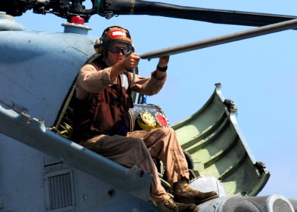 US Navy 090813-N-0515W-024 David Watson with Marine Medium Helicopter Squadron 166 (Reinforced), adjusts weights in the propellers of a CH-46 Sea Knight